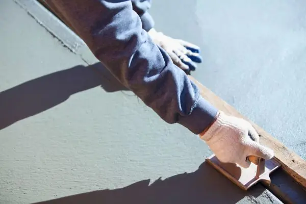 Worker Resurfacing New Concrete Patio