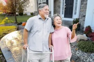 happy couple walking on stamped concrete walkways near their house